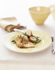 Chicken breast dinner with asparagus and potato.