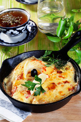 roast pan with mayonnaise sour cream sauce fish and lemon olives parsley 
