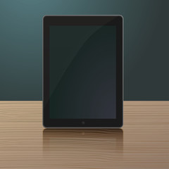 Black tablet computer on wooden table