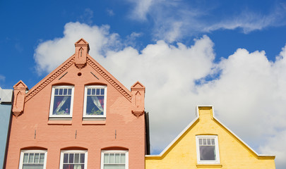 gables of old colorful houses in front of blue sky