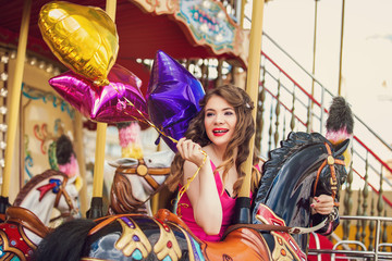 Beautiful young girl on a merry go round