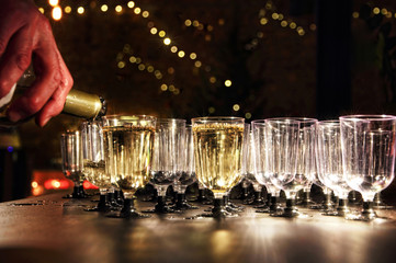Waiter pour wine in glass on holiday reception table with stars