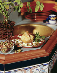 Baklava with bowl of pistachios on table