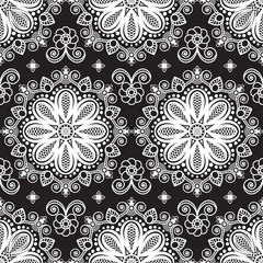 Seamless pattern mehndi background with flowers and lace buta decoration items on black background.
