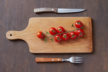 Cherry tomatoes on a cutting board.