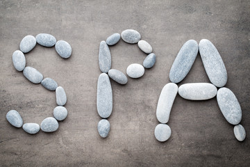 Spa stones on the grey  background.
