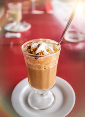 Coffee latte with whipped cream and cinanmon