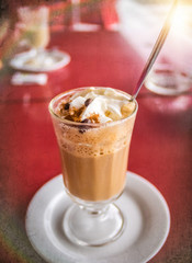 Coffee latte with whipped cream and cinanmon