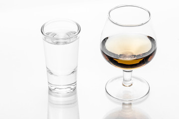 Vodka shot glass and cognac glass isolated on white.