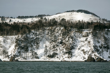 snow-capped mountains near the sea in winter