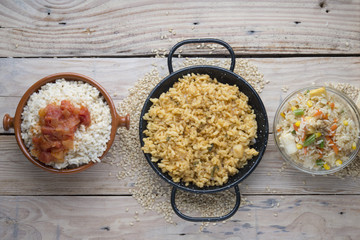 Different rice dishes (paella with vegetables, tomato and rice p