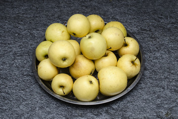 yellow apples on a tray