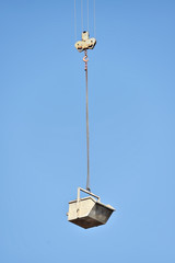 Construction crane loading a container