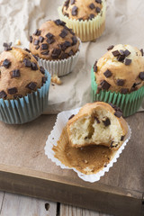 Muffins with chocolate on a wooden table