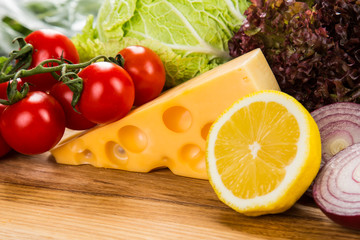 yellow cheese with fresh vegetables