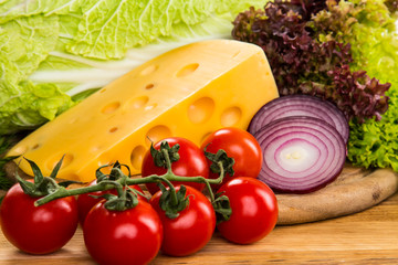 yellow cheese with fresh vegetables