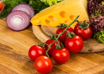 yellow cheese with fresh vegetables