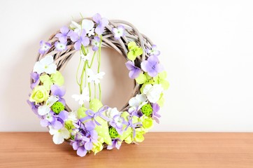 Easter wreath floral home decoration on the table. Homemade arrangement.