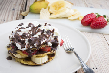 pancakes with strawberries, banana, blueberries and chocolate...