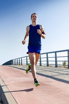 Handsome young man running in the park.