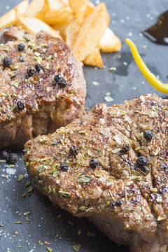 Grilled T-bone steak seasoned with spices and fresh herbs served