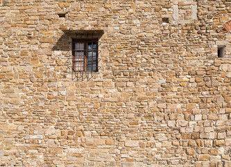 Fototapeta na wymiar Window in the old stone wall