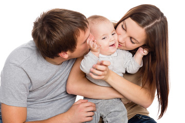 Happy mother and father kissing his son