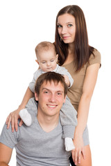 Joyful boy sits on the neck of the father