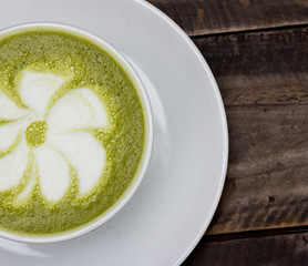 milk green tea on wooden floor