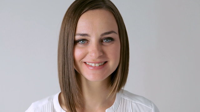 Hand conceal a face. Woman lowers her hand revealing a smiling face