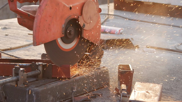 Cutting Steel channel (steel C chanel) with grinder. Sparks while grinding iron