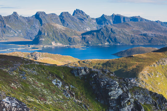 Classic norwegian scandinavian summer mountain landscape view with mountains, fjord, lake with a blue sky, Norway, Lofoten Islands