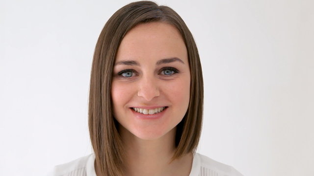 Smiling woman suddenly looks to the right surprised with her mouth open