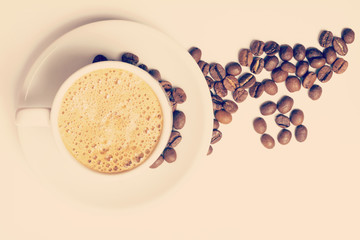 Vintage cup of coffee and roasted beans