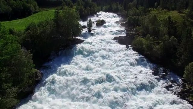 Flying above fast river rapids Vallestadfossen in Norway. Aerial 4k Ultra HD.