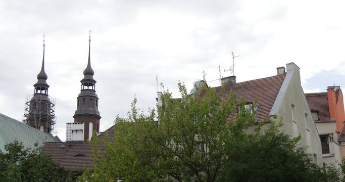 Towers of Cathedral With Crosses Distantly Behind the City Houses Red Roofs Scaffold around Towers of Cathedral Church