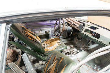 Old damaged interior of a classic car