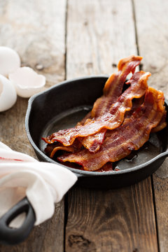Sizzling hot bacon in a cast iron skillet