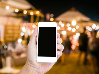 Man hand holding blank screen mobile phone with blur festive gol © littlestocker
