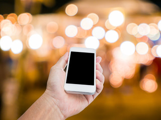 Man hand holding blank screen mobile phone with blur festive gol © littlestocker