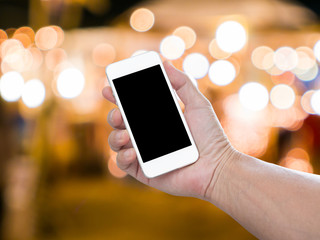 Man hand holding blank screen mobile phone with blur festive gol © littlestocker