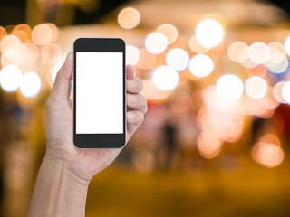 Man hand holding blank screen mobile phone with blur festive gol © littlestocker