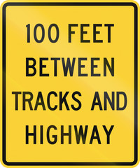 United States MUTCD road sign - 100 Feet between tracks and highway