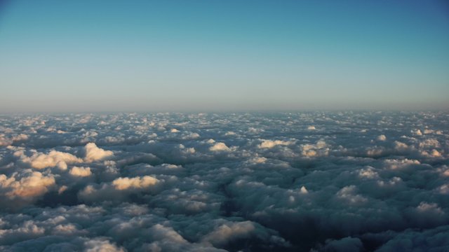 4K timelapse cockpit view's aircraft descending through scattered cloud to landing at the aerodrome