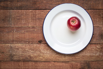 red apple on metal enamel plate