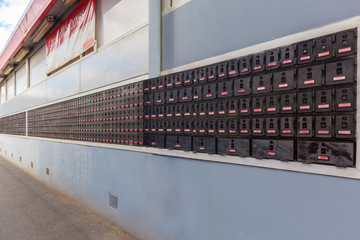 Long row of PO boxes outside Australian post office. Perspective shot.