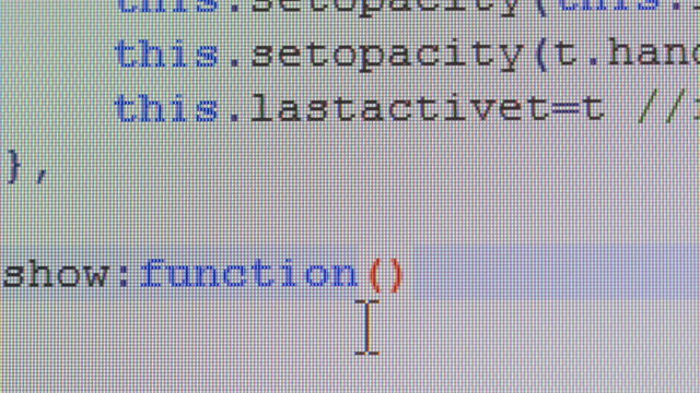Close-up of computer code writing on desktop pc monitor