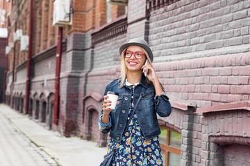 Fototapeta premium Young woman walking down the street