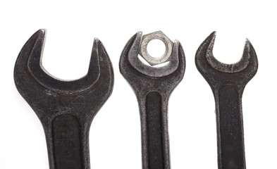old wrenches and nut closeup isolated on white background