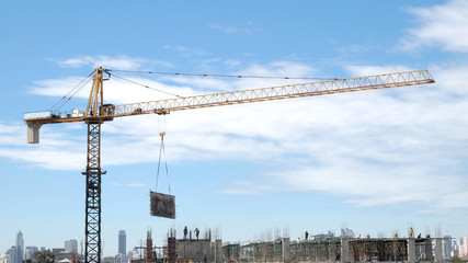 Industrial landscape with cranes on the blue sky